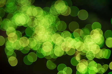 Defocused blur of green light at night backgroundの写真素材