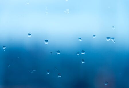 Mirror with rain drop background in blue toneの写真素材