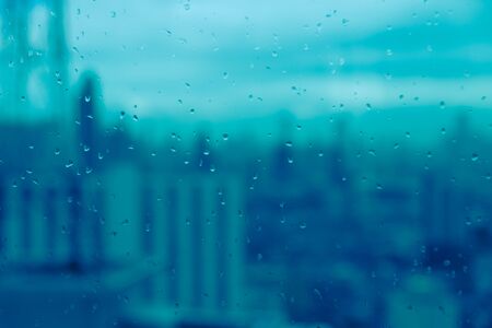 Mirror with rain drops with blur of city view backgroundの写真素材
