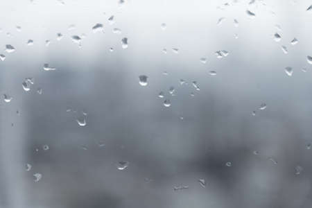 Mirror with rain drop blur background in gray toneの写真素材