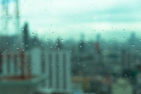 Mirror with rain drops with blur of urban scene backgroundの写真素材