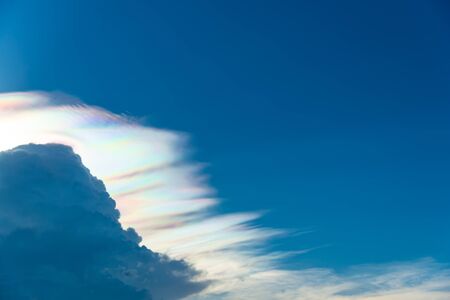 Beautiful rainbow cloud with spectrum from sunshine phenomenonの写真素材