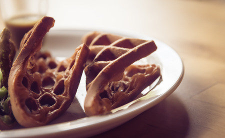 Pieces of chocolate  waffle  on white plate closeup in vintage toneの写真素材