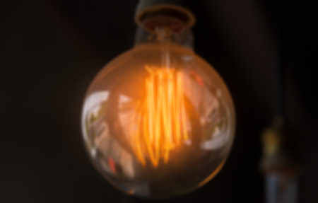 Blur of orange lamp in dark room closeupの写真素材
