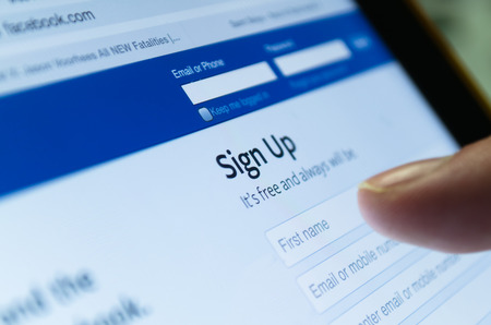 Bangkok, Thailand - June 17, 2015  : Facebook page  ,famous social network company webstie,  with finger touch on First name textboxのeditorial素材