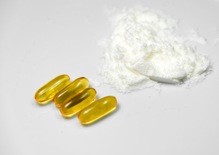 White Collagen powder from sea fish extract and fish oil pills  isolated on white background