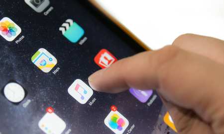 Bangkok, Thailand - July 2, 2015 : Unknow male finger touch on screen to use Apple Music , new music streaming application from Apple Inc.のeditorial素材
