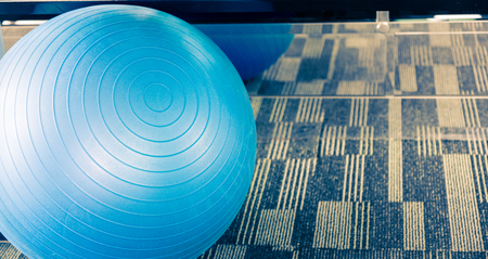 Blue big fitness ball or fitball in split tone in gym near mirror like instagram filterの写真素材