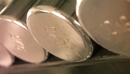 Dumbells closeup golden  vintage tone closeup focused on the rustic 10 kg oneの写真素材