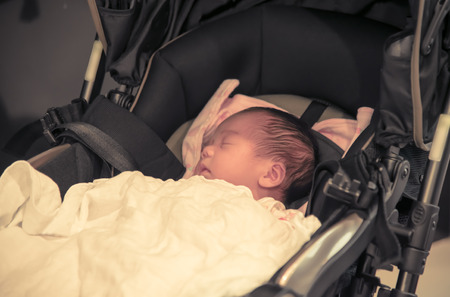 Asian baby sleeping on stroller with pastel tone の写真素材