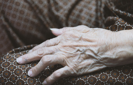 Asian old woman 's hand closeup look like old imageの写真素材