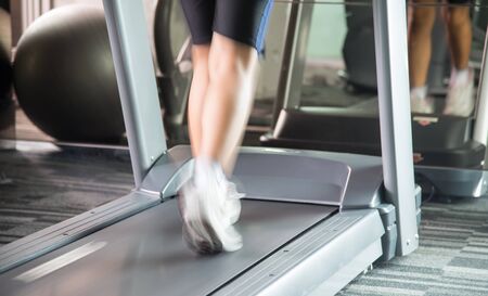 Unknow woman running with treadmill in the gym with motion blur of speed of her running