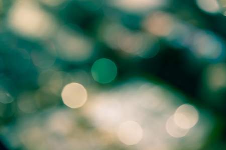 Abstract blur bokeh defocused of light in city  green yellow split-tone backgroundの写真素材