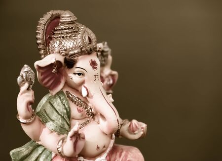 Ganesh Ganapati- Elephant God in Hindusim mythology closeup hold the weapons maze and axe pose right sideの写真素材