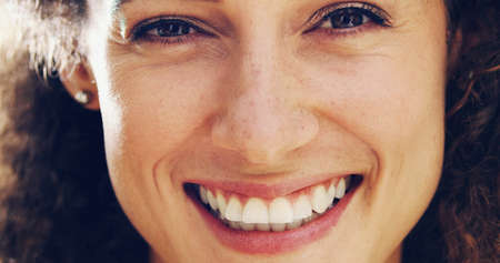 She who is happy is beautiful. Portrait of a happy and attractive woman outside.の写真素材