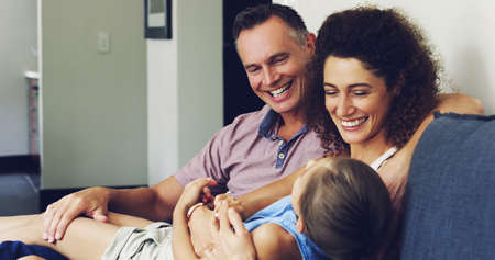 For the best time look no further than family time. Shot of a cute little girl relaxing with her...