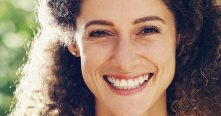 Keep life simple, keep on smiling. Portrait of a happy and attractive woman outside.の写真素材