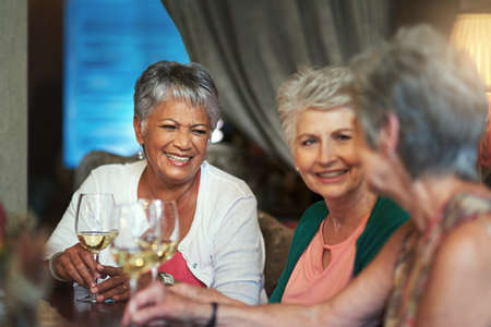 Its always a good time when they get together. Cropped shot of a group of senior female friends enjoying a lunch date.の写真素材