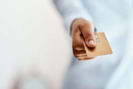 Comes in quite handy doesnt it. Cropped shot of an unrecognizable businesswoman holding a credit...