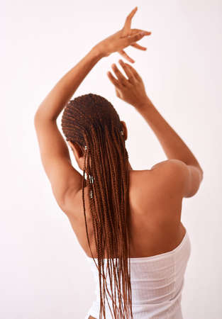 Its all about you. Studio shot of a woman with braids posing with her back towards the camera.の写真素材