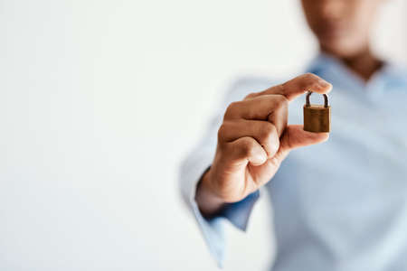Dont leave it to chance. Cropped shot of a businesswoman holding a lock.の写真素材