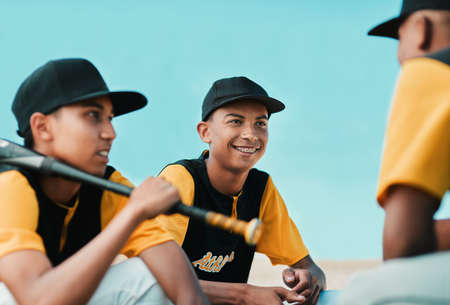 We played really well today. Cropped shot of baseball players chatting while sitting together.の写真素材