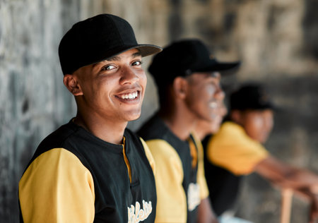 Im happiest when I play baseball. Portrait of a young baseball player sitting with his teammates.の写真素材
