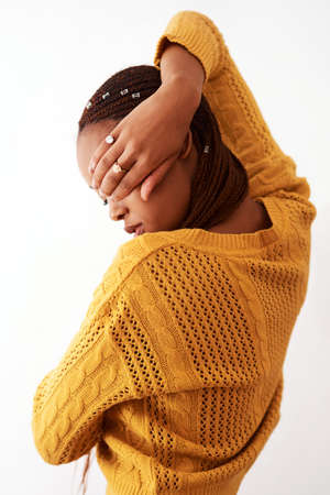You dont always have to show off. Studio shot of a woman holding her hand over her face while posing against a white background.の写真素材