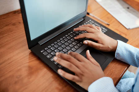 Maximise on productivity with modern technology. Cropped shot of a businesswoman using a laptop at...
