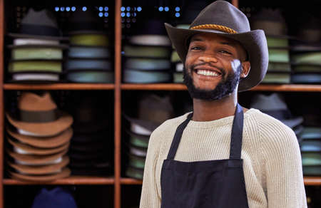 Howdy. Shot of a young man working at his job in a shop.の写真素材