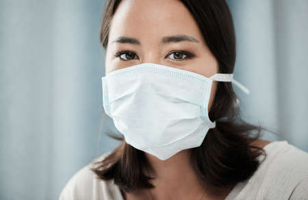 Behind those masks are beautiful strong souls. Closeup shot of a beautiful young woman wearing a mask.の写真素材