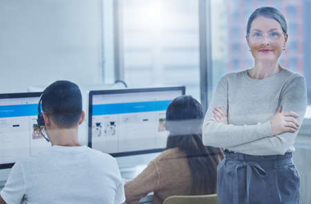 Ensuring that my staff always work at their peak. Shot of a female manager in the office with her staff members.の写真素材