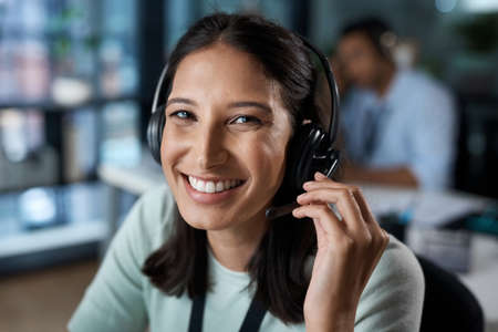 Our customers are our first concern. Portrait of a young woman using a headset in a modern office.
