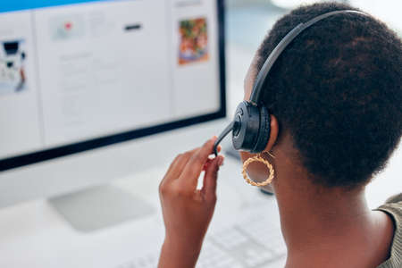 Wed love to hear what you think of our customer service. Shot of a businesswoman wearing a headset while working on her computer.の写真素材