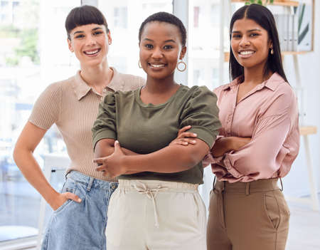 It doesnt matter if you start big or small, just start. Shot of three businesswomen standing together in an office.の写真素材