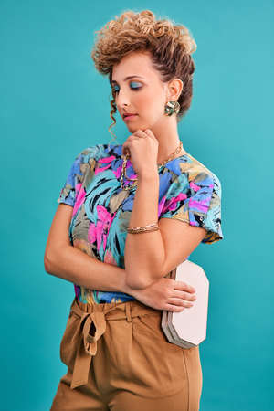 I have the 80s on my mind. Studio shot of a beautiful young woman wearing a 80s outfit.の写真素材