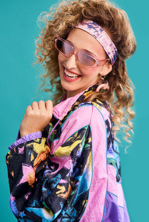 Inspired by the 80s. Studio shot of a beautiful young woman wearing a 80s outfit.の写真素材