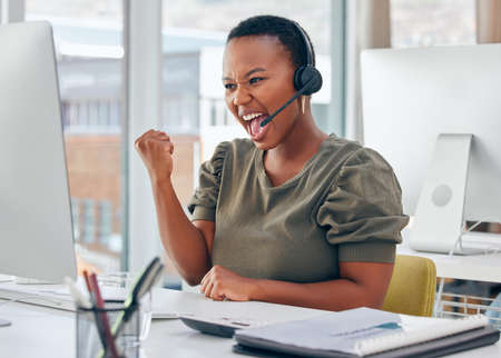 I make more sales than anyone else in my team. Shot of a businesswoman looking cheerful while working in a call centre.の写真素材