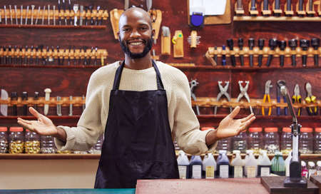 Focus on building your business, be the one left standing. Shot of a young man working at his job in a shop.の写真素材