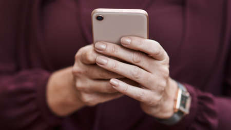 Stay connected and keep up. Cropped shot of an unrecognisable businesswoman using a smartphone.の写真素材