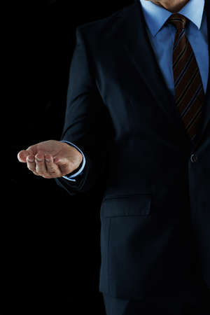 Leading you to business success. Shot of an unrecognizable businessman holding out his hand.の写真素材