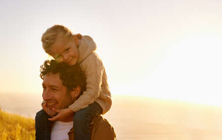 Her daddy and her hero. Cropped shot of a father giving his little girl a ride on his shoulders...