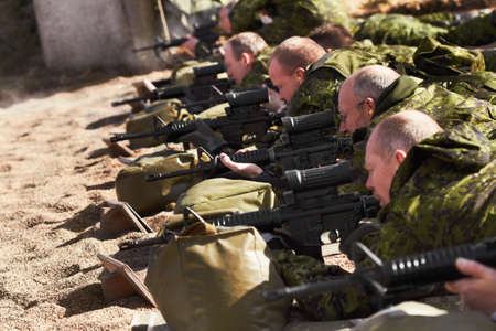 Training to be sharpshooters. A line of soldiers lying and aiming with their guns.