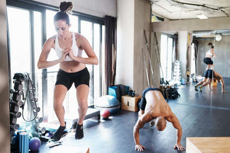 Training to become fighting fit. Shot of a man and woman training together at the gym.