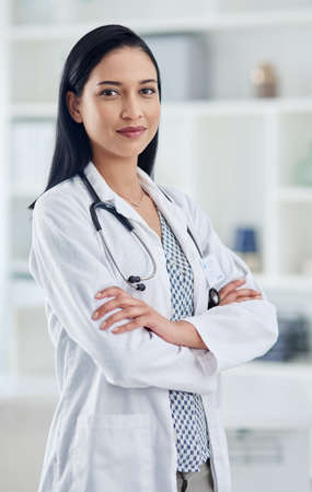 Your health concern is my concern. Portrait of a confident young doctor working in a clinic.の写真素材