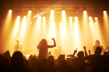Rear view of a crowd cheering at a concert- This concert was created for the sole purpose of this photo shoot, featuring 300 models and 3 live bands. All people in this shoot are model releasedの写真素材