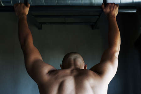 Getting a great upper body workout with some pull-upsの写真素材