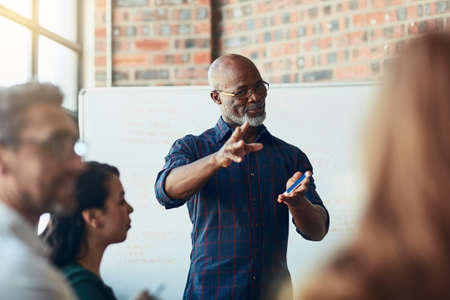 Now theres an idea. Cropped shot of a mature businessman giving a presentation in the boardroom.の写真素材