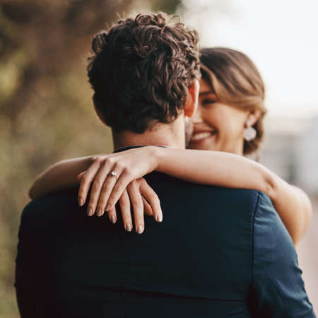 Now Mr and Mrs. Shot of a happy young couple standing together on their wedding day.の写真素材