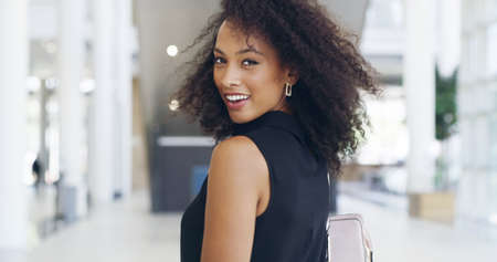 If you want success, follow me. Cropped shot of a young beautiful businesswoman in a modern office.の写真素材